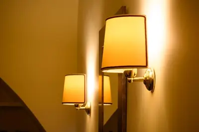 a pair of lights on a wall next to a mirror at Apartment Margutta Center in Rome