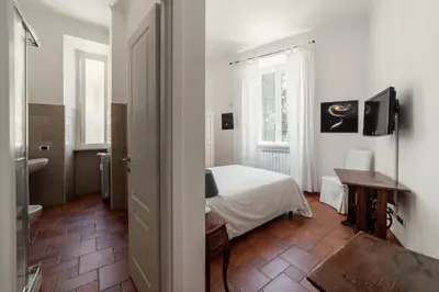 a bedroom with a bed and a table in a room at B&B Domus Quiritum in Rome