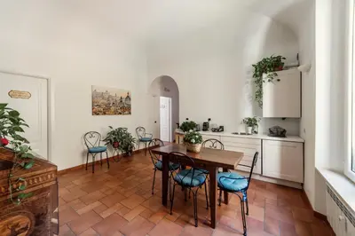 a kitchen and dining room with a table and chairs at B&B Domus Quiritum in Rome