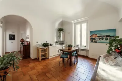 a kitchen with a table and chairs and a window at B&B Domus Quiritum in Rome