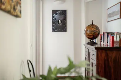 a room with a book shelf and a globe on the wall at B&B Domus Quiritum in Rome