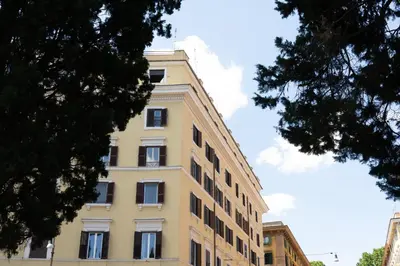 a tall yellow building with windows on the side of it at B&B Domus Quiritum in Rome