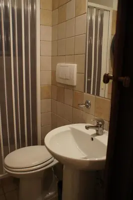 a bathroom with a toilet and a sink at Hotel Il Papavero in Rome