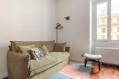 a living room with a couch and a window at Buonanotte Colosseo in Rome