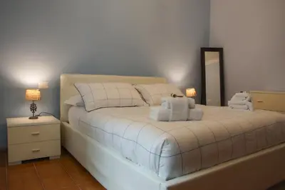 a bedroom with a white bed with towels on it at Family`s Apartment Trastevere in Rome