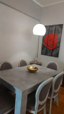 a dining room table with chairs and a bowl on it at Family`s Apartment Trastevere in Rome