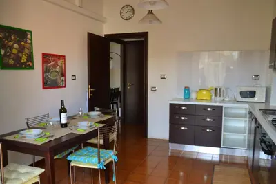a kitchen with a table with chairs and a dining room at Family`s Apartment Trastevere in Rome