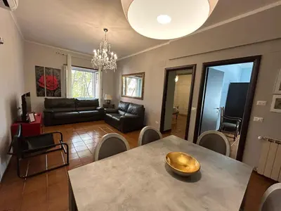a living room with a table and a couch at Family`s Apartment Trastevere in Rome