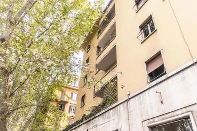 a tall building with windows on the side of it at Family`s Apartment Trastevere in Rome