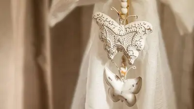 two butterflies are hanging on a white curtain at Sweet Rooms Piramide Bed and Breakfast in Rome