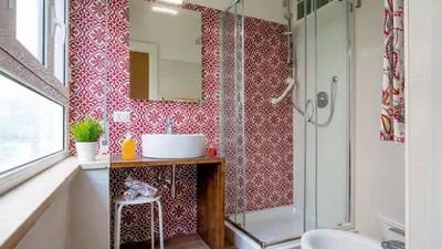 a bathroom with a shower and a sink and a mirror at Sweet Rooms Piramide Bed and Breakfast in Rome