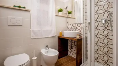 a bathroom with a toilet and a sink and a shower at Sweet Rooms Piramide Bed and Breakfast in Rome