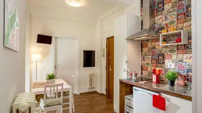 a kitchen and dining room with a table and a counter at Sweet Rooms Piramide Bed and Breakfast in Rome