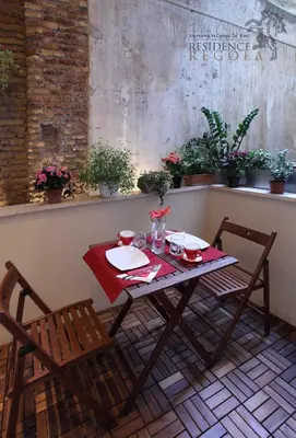 a table and chairs sitting on a patio with a table and chairs at Residence Regola in Rome