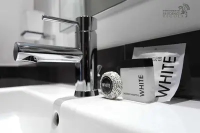a sink with a faucet and a cup of coffee at Residence Regola in Rome
