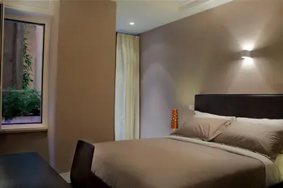 a bedroom with a large bed and a window at Residence Regola in Rome