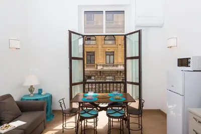 a small living room with a table and chairs at Prestigious Apartment via Barberini in Rome