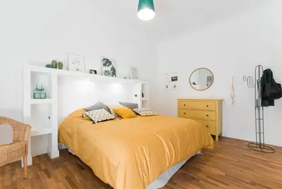 a bedroom with a bed with a yellow blanket at Be Rome in Rome