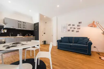 a living room with a blue couch and a table at Be Rome in Rome