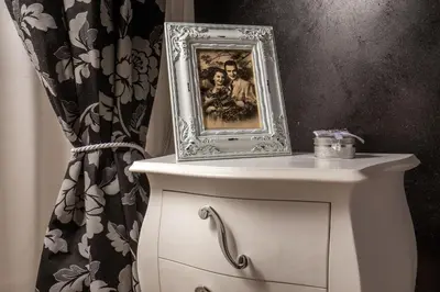 a picture frame on top of a dresser with a curtain at I Fiumi Di Navona in Rome