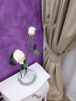 two white roses in a vase on a table at I Fiumi Di Navona in Rome