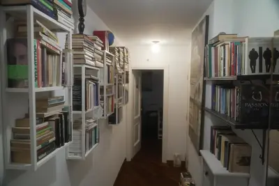 a hallway with book shelves filled with books at Casa Mia Guesthouse in Rome