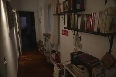 a hallway with shelves of books on the wall at Casa Mia Guesthouse in Rome
