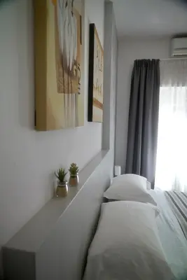 a bedroom with a bed with a mirror and a window at Casa Mia Guesthouse in Rome