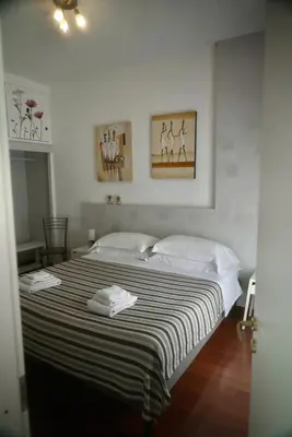 a bedroom with a bed with two white towels on it at Casa Mia Guesthouse in Rome