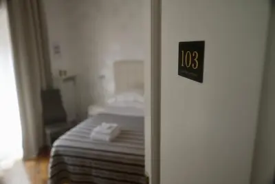 a bedroom with a bed and a clock on the door at Casa Mia Guesthouse in Rome