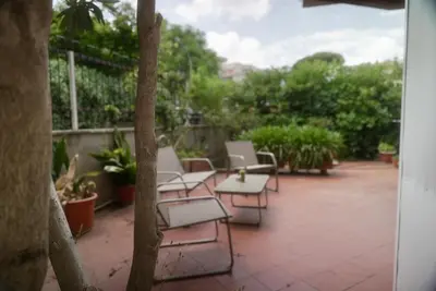 a group of chairs sitting on a patio at Casa Mia Guesthouse in Rome
