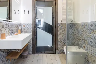 a bathroom with a sink and a mirror at Colosseo Apartment Holiday - Attico al Colosseo a Monti in Rome