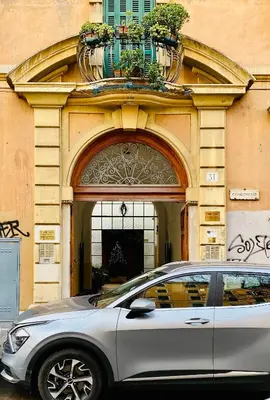 a silver car parked in front of a building at Colosseo Apartment Holiday - Attico al Colosseo a Monti in Rome