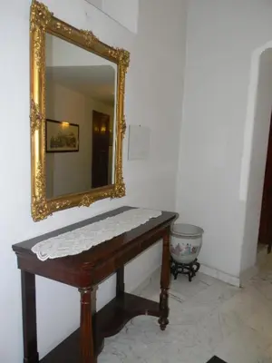 a mirror and a bench in a room with a mirror at Hotel Primavera in Rome