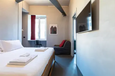 a bedroom with a bed with towels on it at Pietra - The Italian Stay Collection in Rome