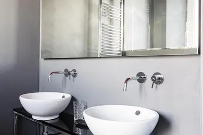 a bathroom with a white sink and a mirror at Pietra - The Italian Stay Collection in Rome