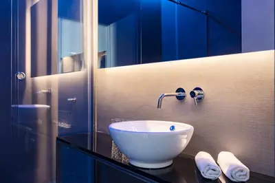 a bathroom with a white bowl sink on a counter at Pietra - The Italian Stay Collection in Rome