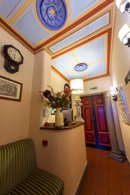 a waiting room with a couch and a clock on the ceiling at Hotel Al SanPietrino in Rome
