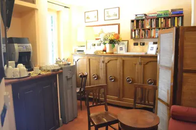a kitchen with wooden cabinets and a table and chairs at Hotel Al SanPietrino in Rome