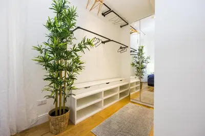 a living room with plants and a mirror at Maestoso Locazione Turistica in Rome