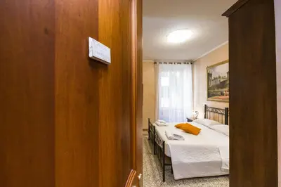 a bedroom with two beds and a door to a room at Maestoso Locazione Turistica in Rome