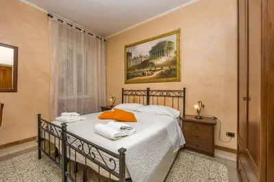 a bedroom with a bed with towels on it at Maestoso Locazione Turistica in Rome