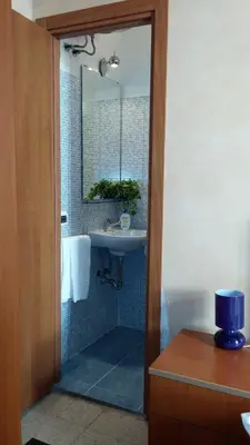 a bathroom with a sink and a mirror at Maestoso Locazione Turistica in Rome