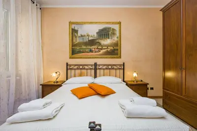 a bedroom with a large white bed with two pillows at Maestoso Locazione Turistica in Rome