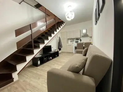 a living room with a couch and a staircase at The Place In Rome Guest House in Rome