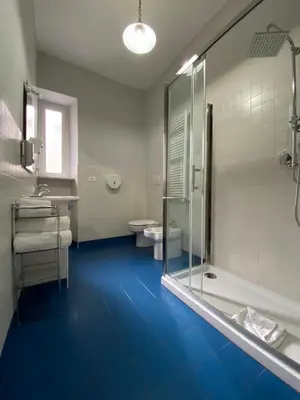 a bathroom with two toilets and a glass shower at The Place In Rome Guest House in Rome