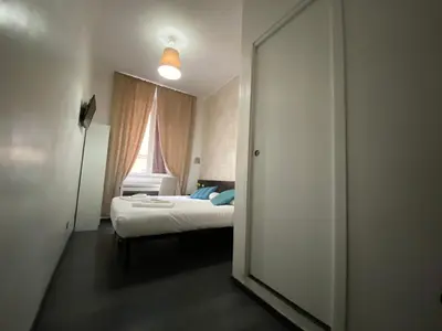 a bedroom with a bed and a large mirror at The Place In Rome Guest House in Rome