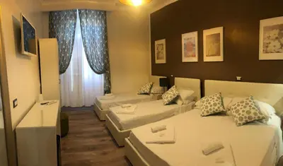 a room with two beds and a living room at The Place In Rome Guest House in Rome