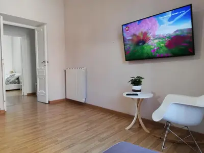 a living room with a tv hanging on a wall at Residenza a San Pietro in Rome