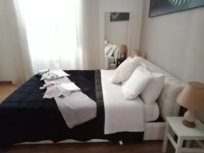 a bedroom with a bed and a white couch at Residenza a San Pietro in Rome